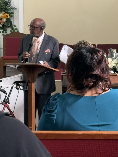Pastor Rev. E. C. Huntley at the pulpit